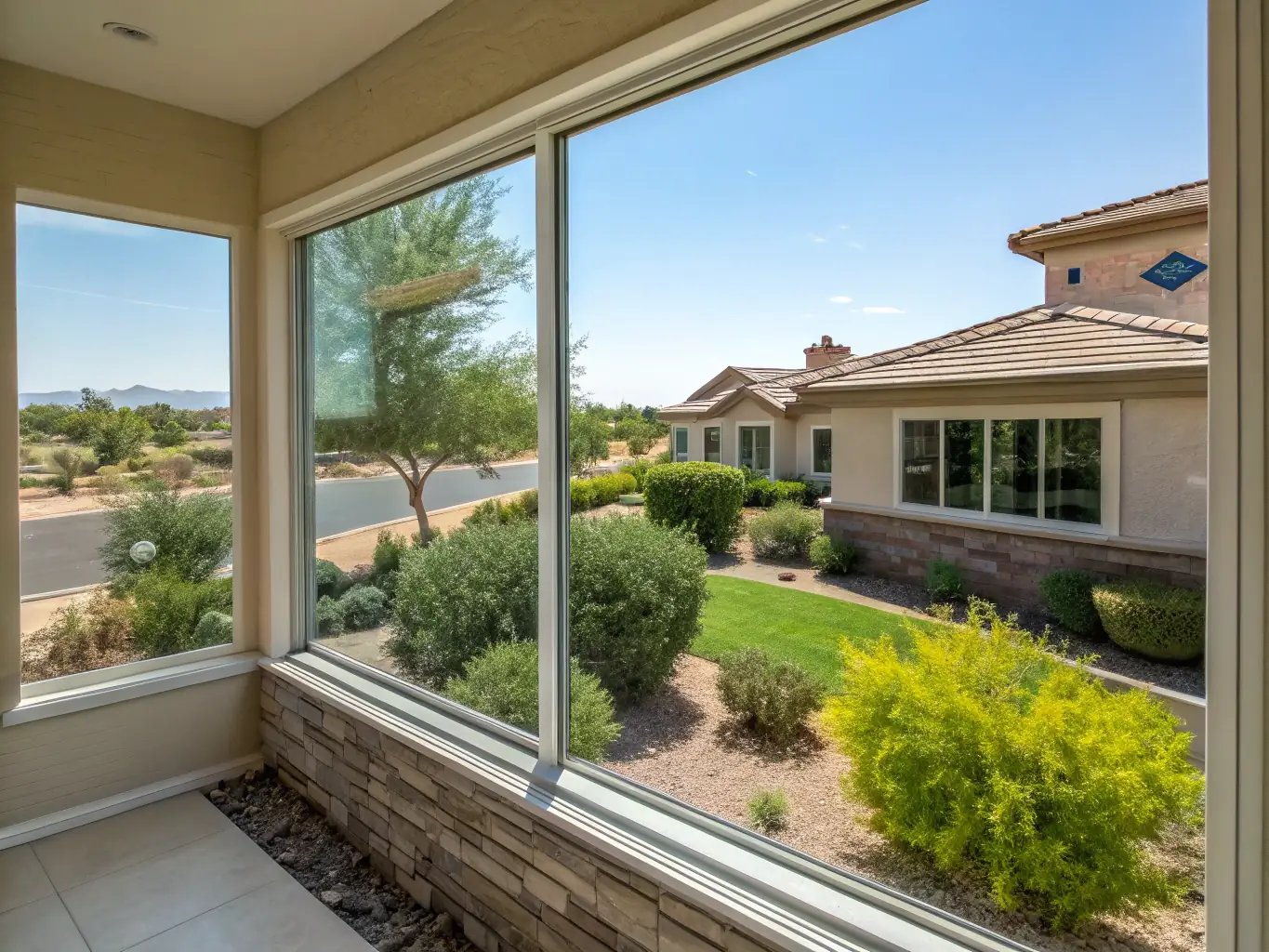 A set of sparkling clean windows on a residential home, reflecting the sky and showcasing the clarity achieved by Tech Town Pressure Washing's window cleaning service. The image should highlight the improved view and natural light.